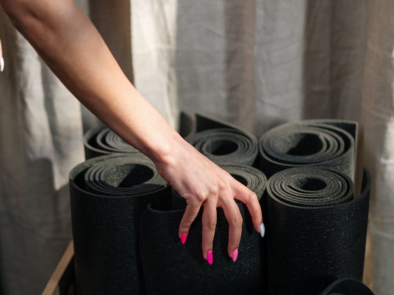 Detailed close-up of hands on a yoga mat representing stability