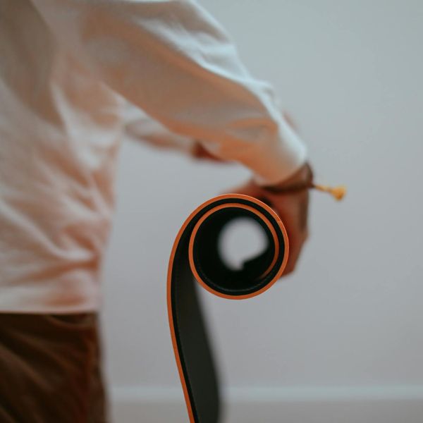 Roll of professional yoga mat in a dark room